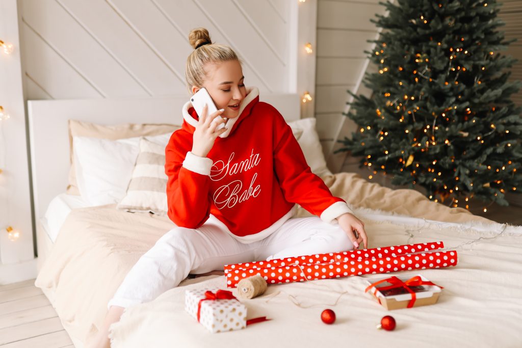 A lady is wearing Christmas pajamas