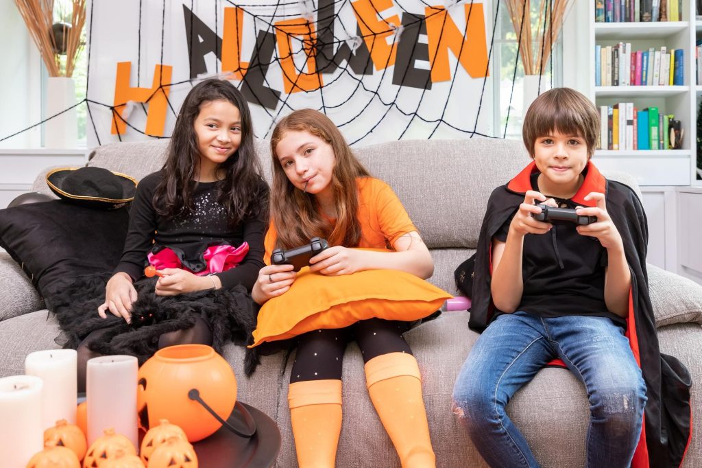 Children dressed in halloween family pajamas are having fun playing games!