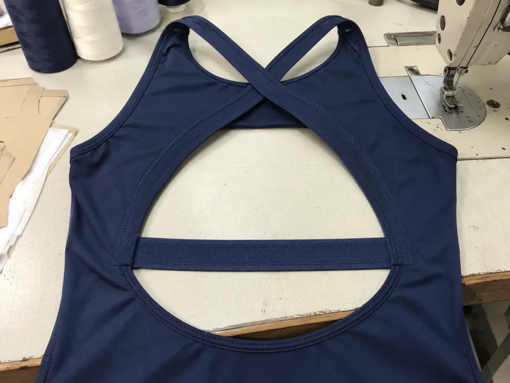 open back leotard construction showing horizontal back elastic and crossover strap placement